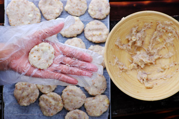 Woman hand make cassava pies on furnace bar to bake pastry