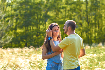 Lovers. A young couple. The guy with the girl are walking in the forest. Loving couple hugs sensually. Lovers man and woman in the arms of each other. Romantic walk in the forest. Loving relationship