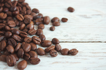 Coffee beans on a light wooden background