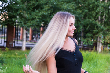 Obraz premium Portrait of a cute girl with long blonde hair. Hair care concept.