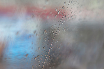 Abstract background with rain drops on glass. Close-up, copy space, soft focus
