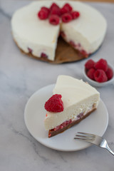 Cheesecake slice with raspberries on a plate