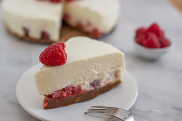 Cheesecake slice with raspberries on a plate