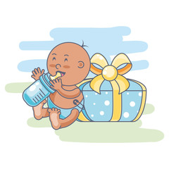 cute baby boy with bottle milk and gift box