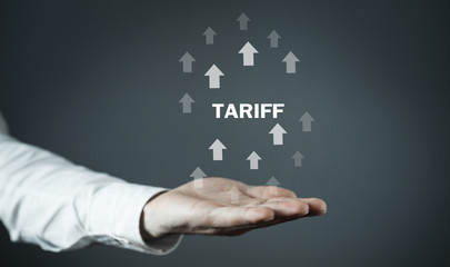 Man holding Tariff word with arrows.