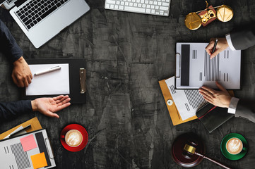 top view Business and lawyers discussing contract papers with brass scale on desk in office. Law,...