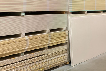 The stack of gypsum board preparing for construction. Gypsum plasterboard in the pack