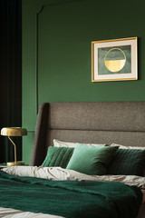 Green cushions and blanket on the bed in glamour bedroom