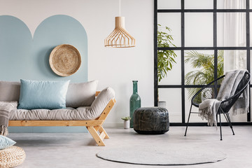 Urban jungle in bright white and blue living room interior with scandinavian futon sofa - obrazy, fototapety, plakaty