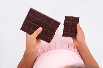 Beautiful little girl taste chocolate like a pro - breaking cacao bar