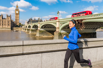 London city lifestyle sport woman running near Big Ben. Asian girl runner jogging training at...