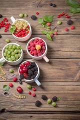 different berries on old wooden background