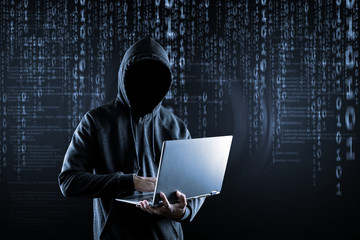 Cybercrime, hacking and technology crime. no face hacker with laptop.