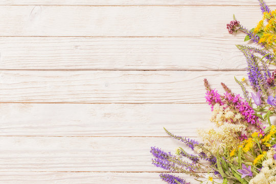 Wildflowers On White Wooden Background