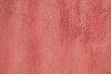 Red pink color painted rough polished cement wall, concrete texture background.