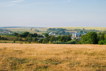 Ukrainian Village of Porokhova in the valley between the hills in the evening sun. Panorama. Copy space.