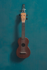 Naklejka premium ukulele in front view with isolated blue background