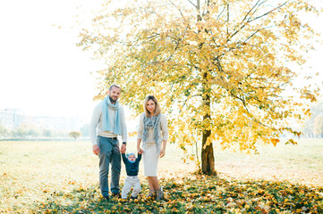 Family couple posing outdoor with their beautiful baby.