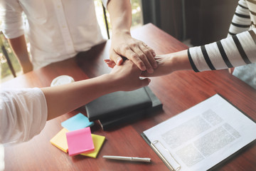 Group of young people put hands stack together, teamwork concept.