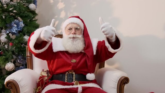Santa Claus showing thumb-up. Santa Claus with real beard and great smiling giving thumb up. Cinematic 4K.