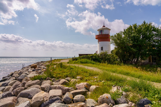 Small lighthouse with a footpath and the coast of the Baltic Sea on the island langeland