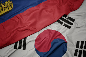 waving colorful flag of south korea and national flag of liechtenstein.