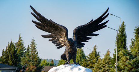 hawk statue among the sky and trees