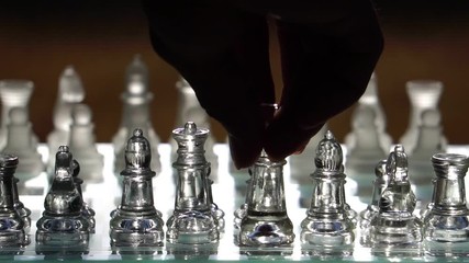The concept of business competition: Close-up of a businessman holding a glass chess footage slow motion