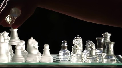 The concept of business competition: Close-up of a businessman holding a glass chess footage slow motion