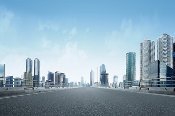 Asphalt road with modern building and skyscrapers