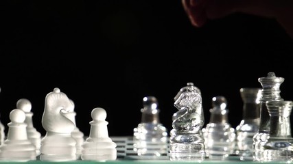 The concept of business competition: Close-up of a businessman holding a glass chess footage slow motion