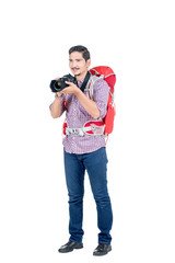 Asian man with a backpack holding a camera to take pictures