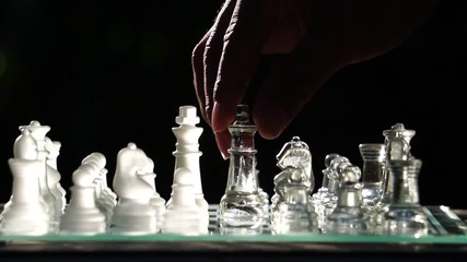 The concept of business competition: Close-up of a businessman holding a glass chess footage slow motion