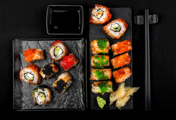 Set of sushi rolls on stone table. Top view with copy space.