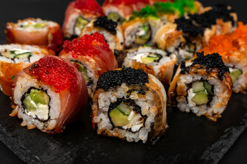 Dragon set sushi roll. Red, golden with avocado, salmon and caviar.