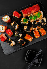 Set of sushi rolls on stone table. Top view with copy space.