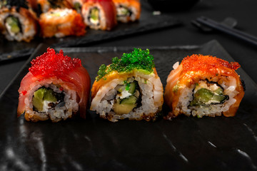 Beautiful sushi, rolls, with eel and rice, with sauce and caviar.