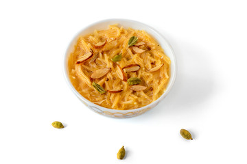 Vermicelli dessert, popular sweet dish know a kheer made with milk and garnish with dry fruits isolated on white background, served in bowl. Selective focus. Top view.