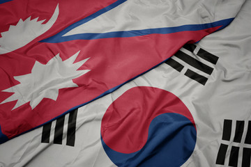 waving colorful flag of south korea and national flag of nepal.