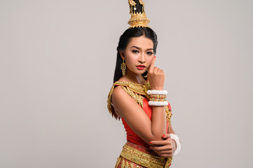 Beautiful Thai woman wearing Thai dress and looking to the side