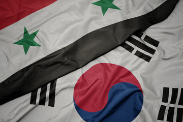 waving colorful flag of south korea and national flag of syria.