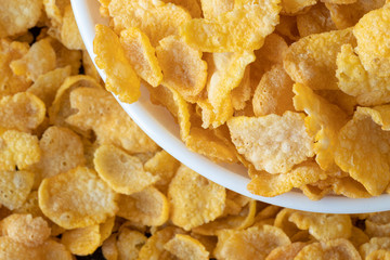 Cornflakes in blowl, a delicious and healthy dietary breakfast cereal. Selective Focus. Top View