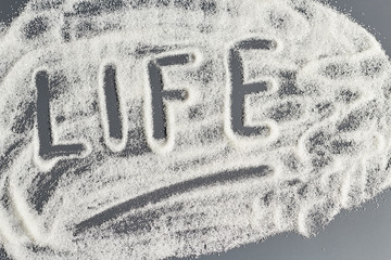 Beautiful background of sugar with the word life.