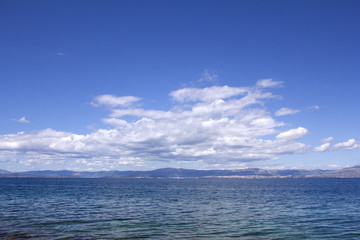 Naklejka na ściany i meble Panorama sky with clouds and water of sea