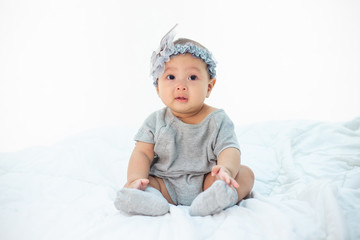 The little boy sitting on the bed