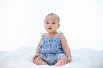 Fototapeta premium The little boy sitting on the bed