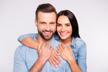 Close up photo of sweet lady and guy with toothy smile cuddling wearing denim jeans shirt isolated...