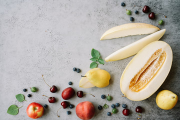 Fresh melon piece, pears and berries. Creative layout ripe fruits. Food concept