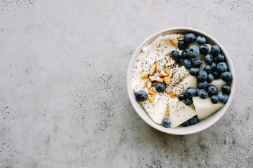 Breakfast bowl with cottage cheese or yogurt, blueberries, chia seeds and almonds. Healthy breakfast concept