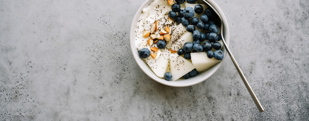 Breakfast bowl with cottage cheese or yogurt, blueberries, chia seeds and almonds. Healthy breakfast concept